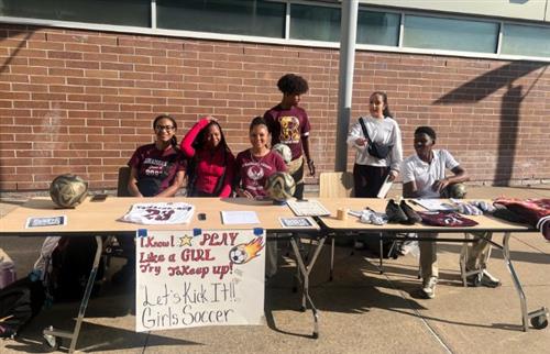 Girls soccer team members posing